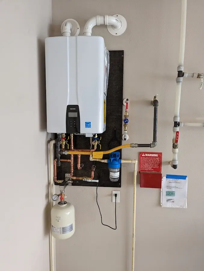 Professional plumber installing copper piping in a Bacliff home